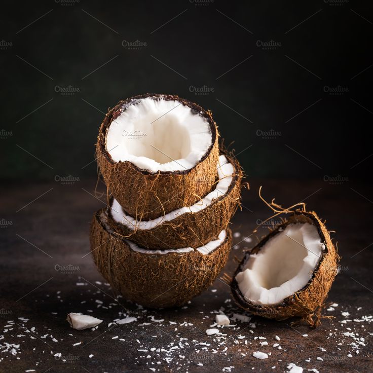 stack of coconut half on dark brown